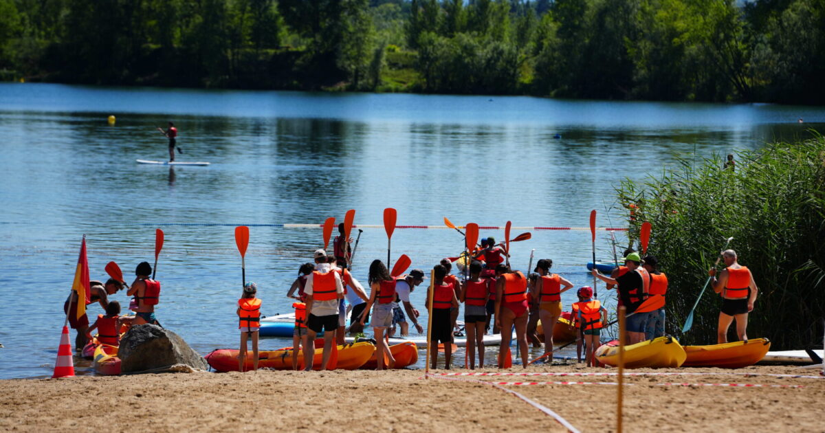 Photo montrant un groupe se préparant à entrer dans des canoé pour une ballade sur le lac de Villefranche